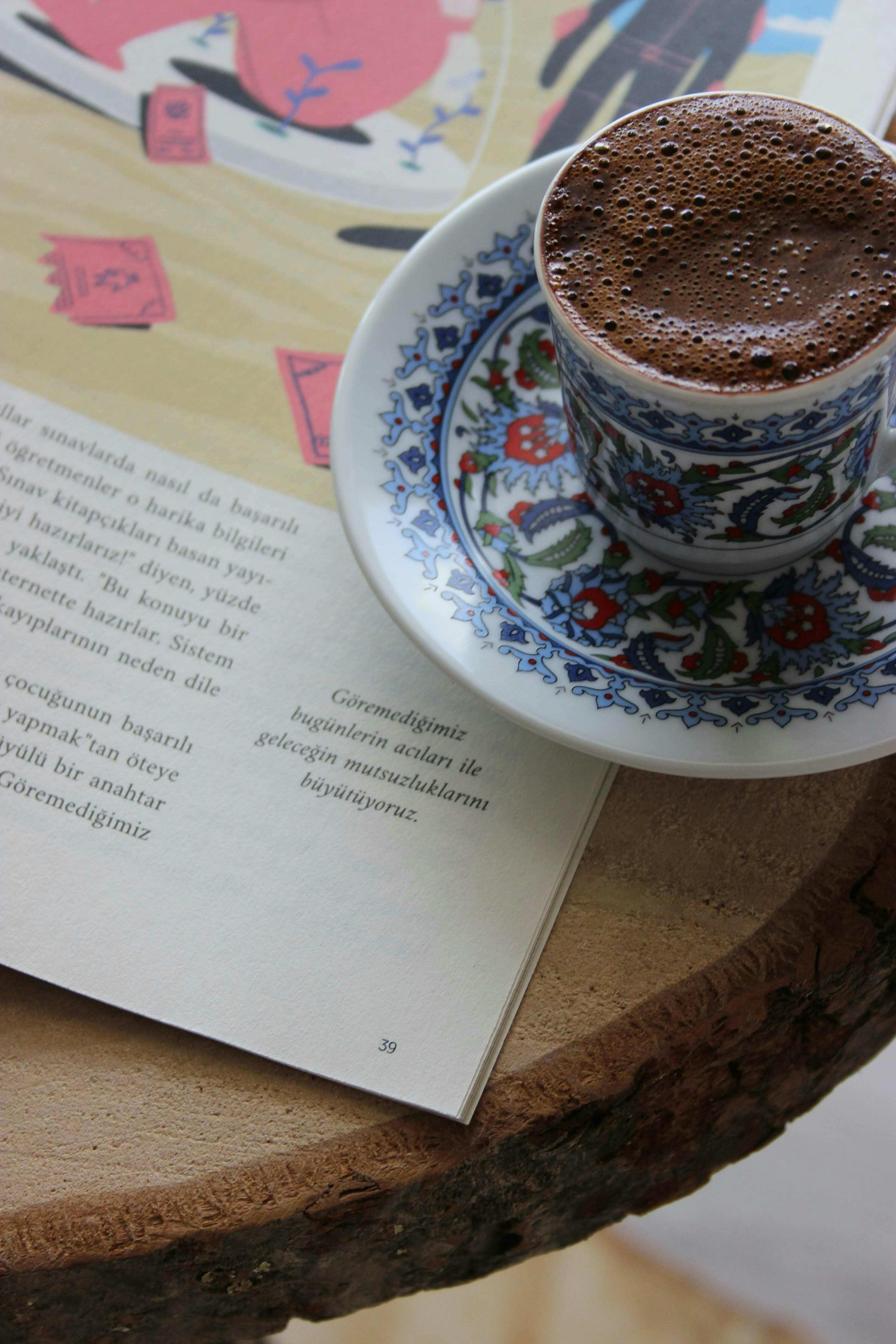 A small cup of rich ceremonial cacao resting on a patterned saucer