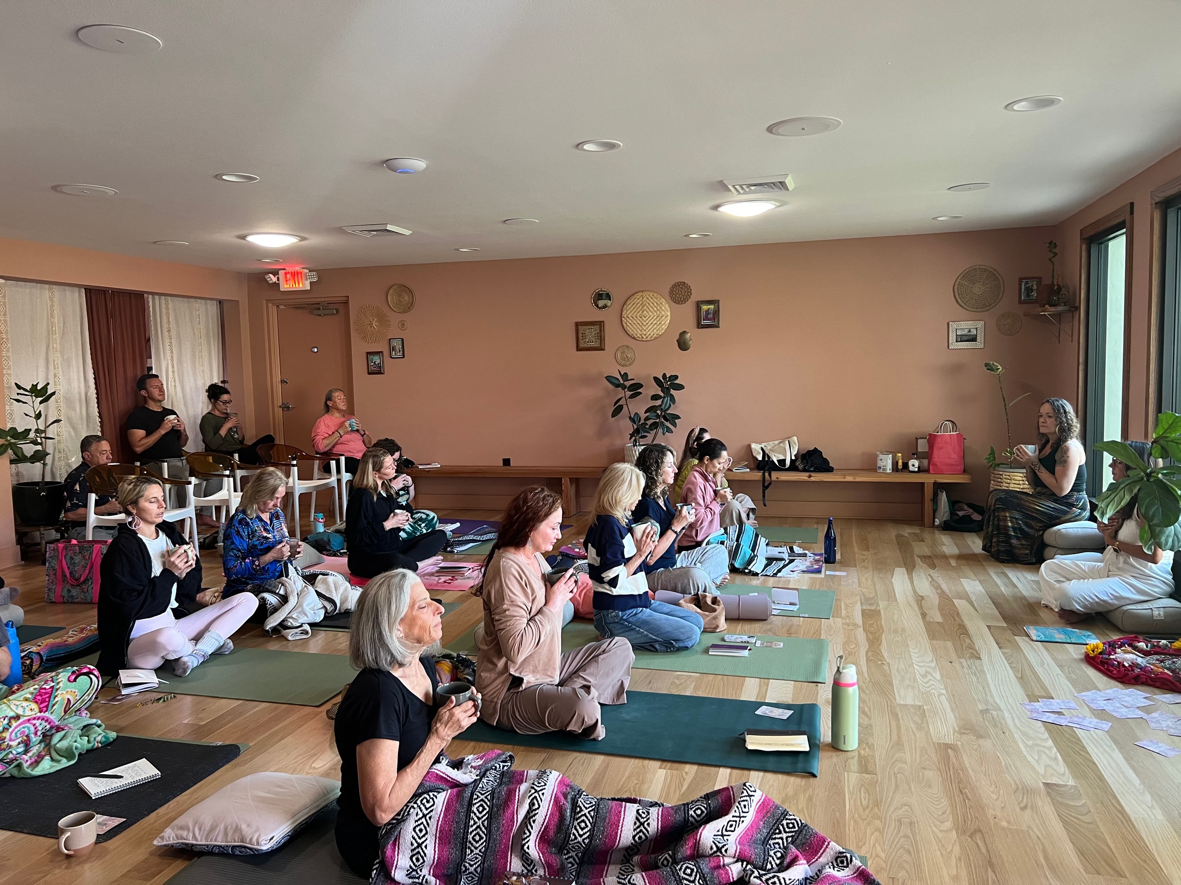 A circle of people gathered for a cacao and wellness workshop